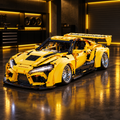 Yellow GT Supra-style LEGO Technic model in a dark premium garage with yellow ambient glow