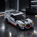 Ash Striker GTS LEGO model in a dark premium garage setting